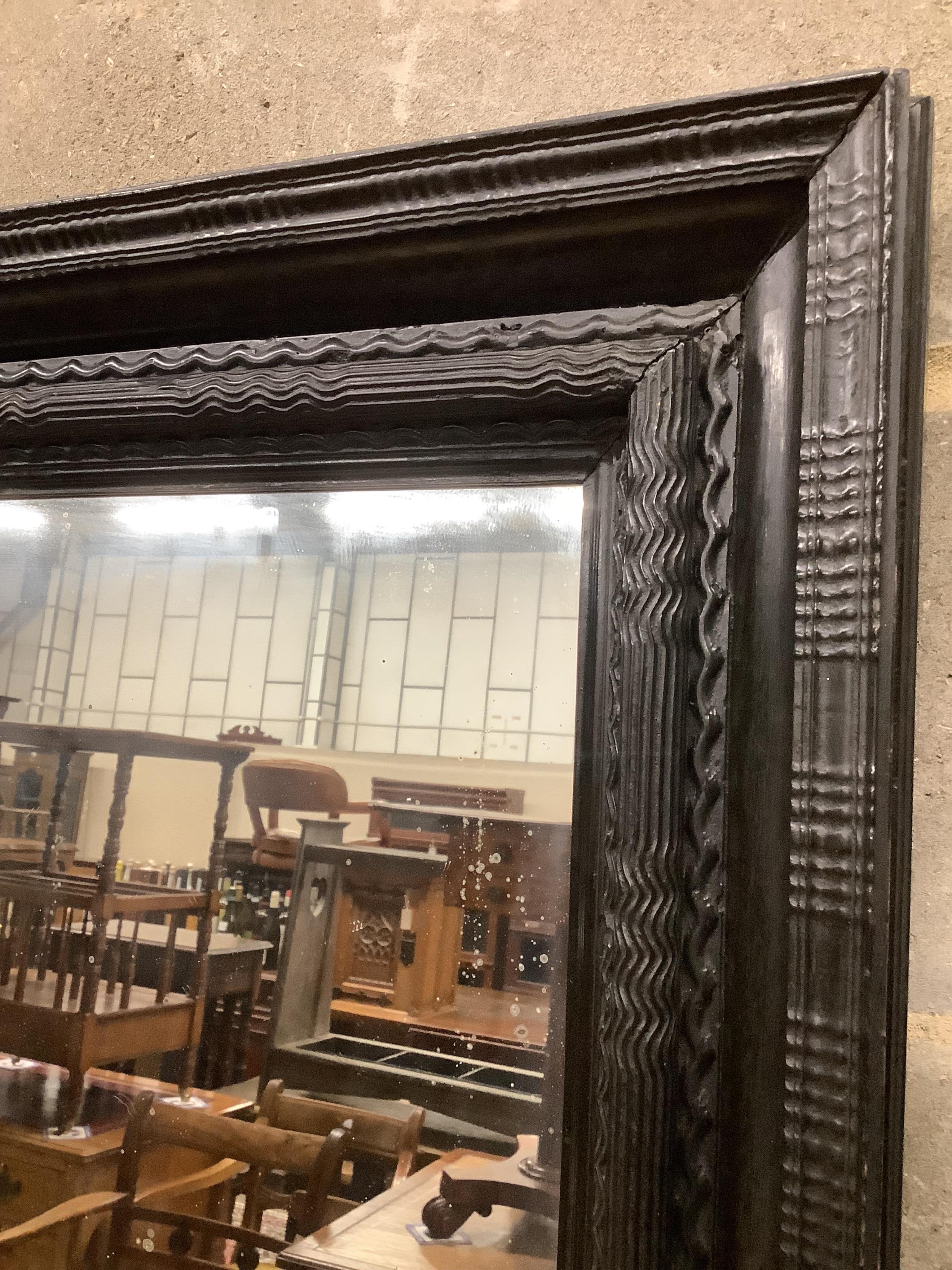 A Dutch ebonised ripple moulded frame, now a wall mirror, width 61cm, height 74cm. Condition - good